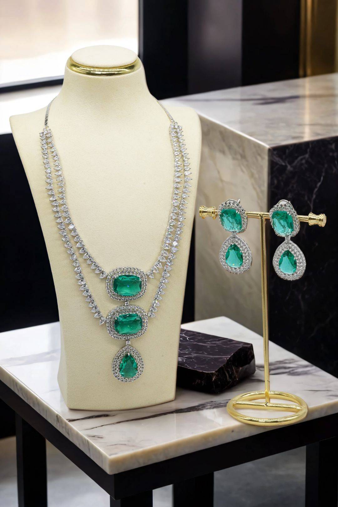 Kyna - Emerald Teardrop Statement Earrings and Necklace Set on Display