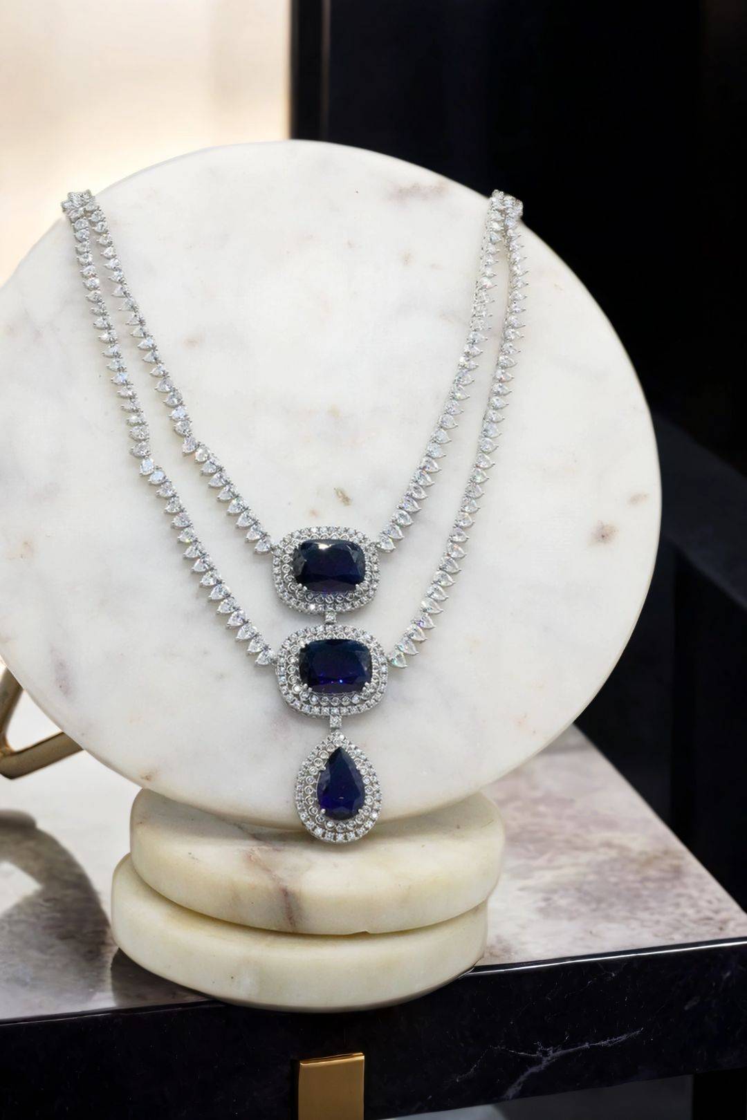 Kyna - Sapphire Teardrop Statement Earrings and Necklace Set on Display