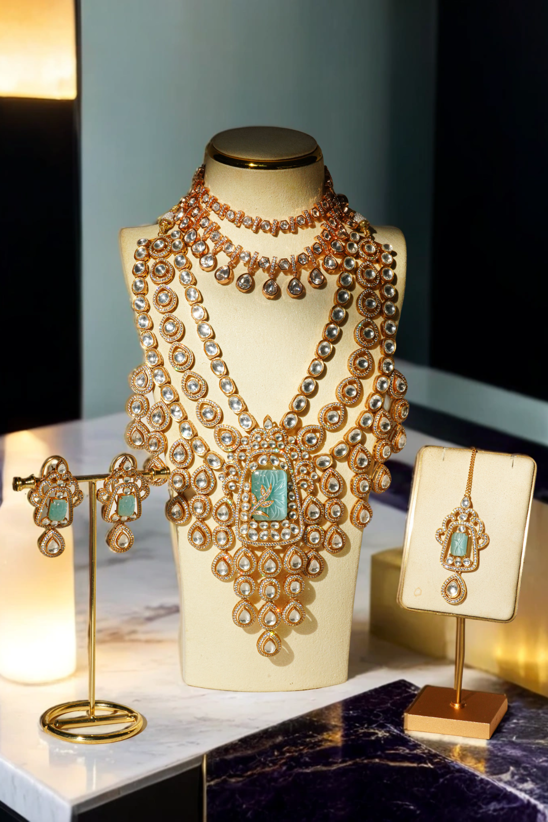 Siham Indian bridal jewelry set with moissanite Polki stones, featuring a gold-plated choker necklace, long cascading necklace, maang tikka, and earrings displayed elegantly.