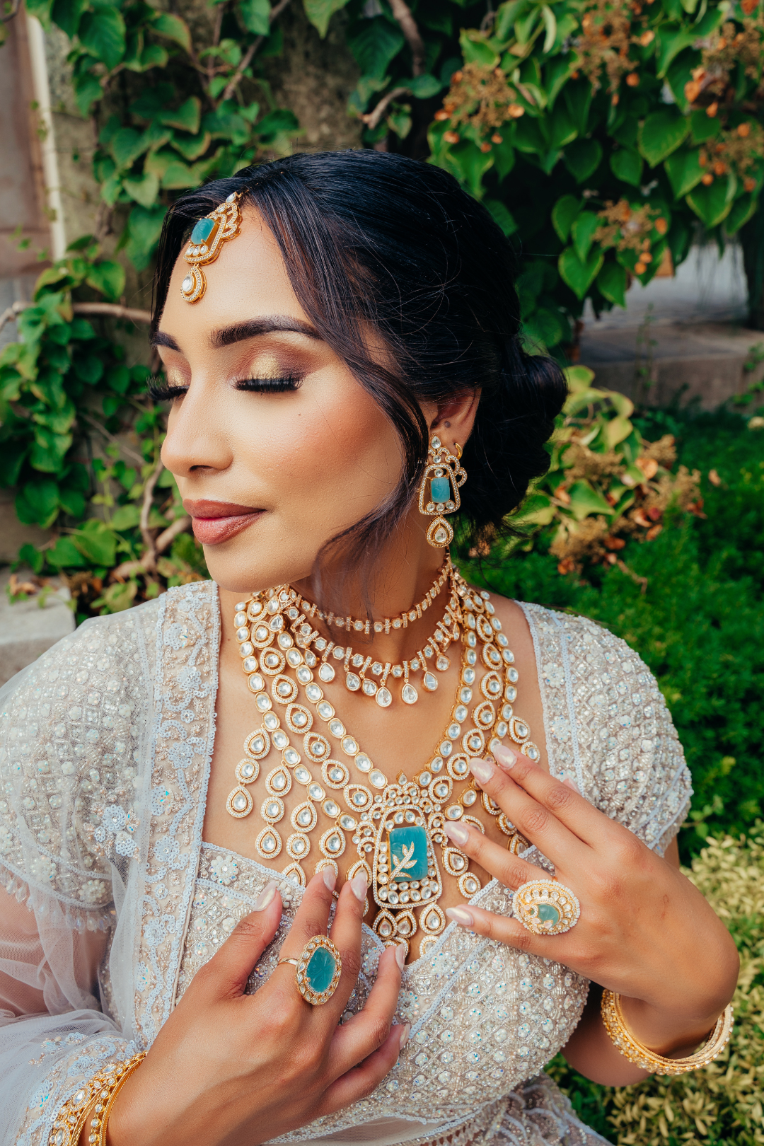 Siham Indian bridal jewelry set with moissanite Polki stones, featuring a gold-plated choker necklace, long cascading necklace, maang tikka, and earrings displayed elegantly.