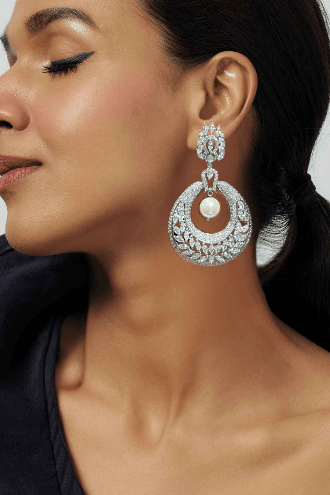 Esmeralda rhodium-plated crescent earrings with white stones and pearl drop, Indian jewelry, 2.8 inches long, for parties and weddings.