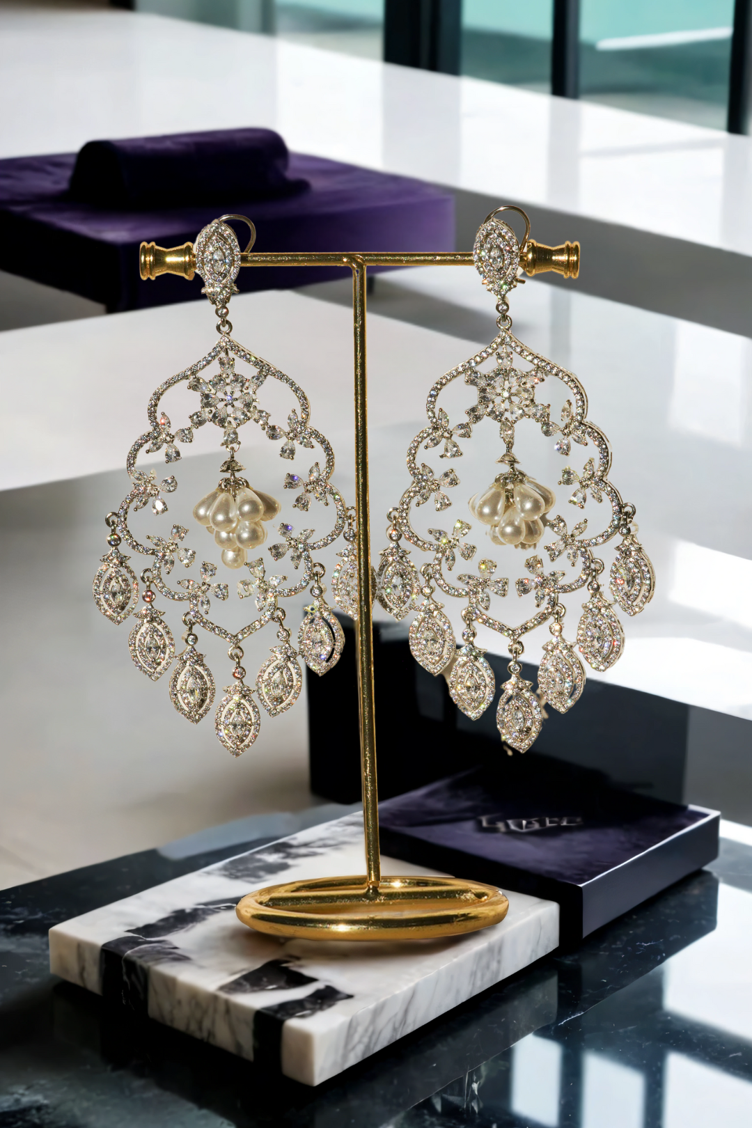 Julia Rhodium-Plated Statement Earrings with intricate detailing, 4.5-inch length, lightweight design, adorned with sparkling stones and pear-shaped dangles.