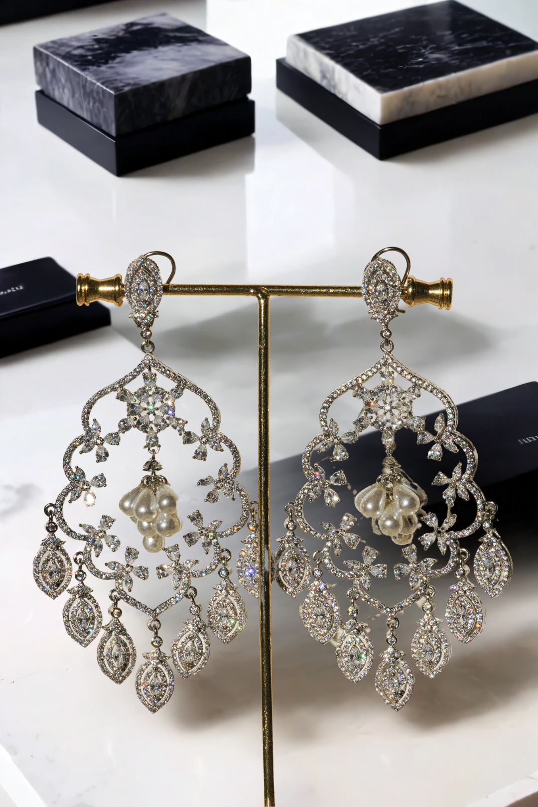 Julia Rhodium-Plated Statement Earrings with intricate detailing, 4.5-inch length, lightweight design, adorned with sparkling stones and pear-shaped dangles.