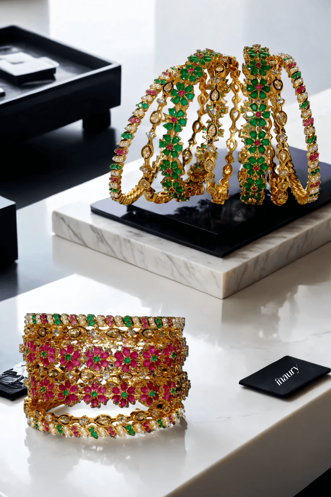 Meera 7-piece gold-plated bangle set with ruby and emerald accents from Inaury, floral design with diamante stones