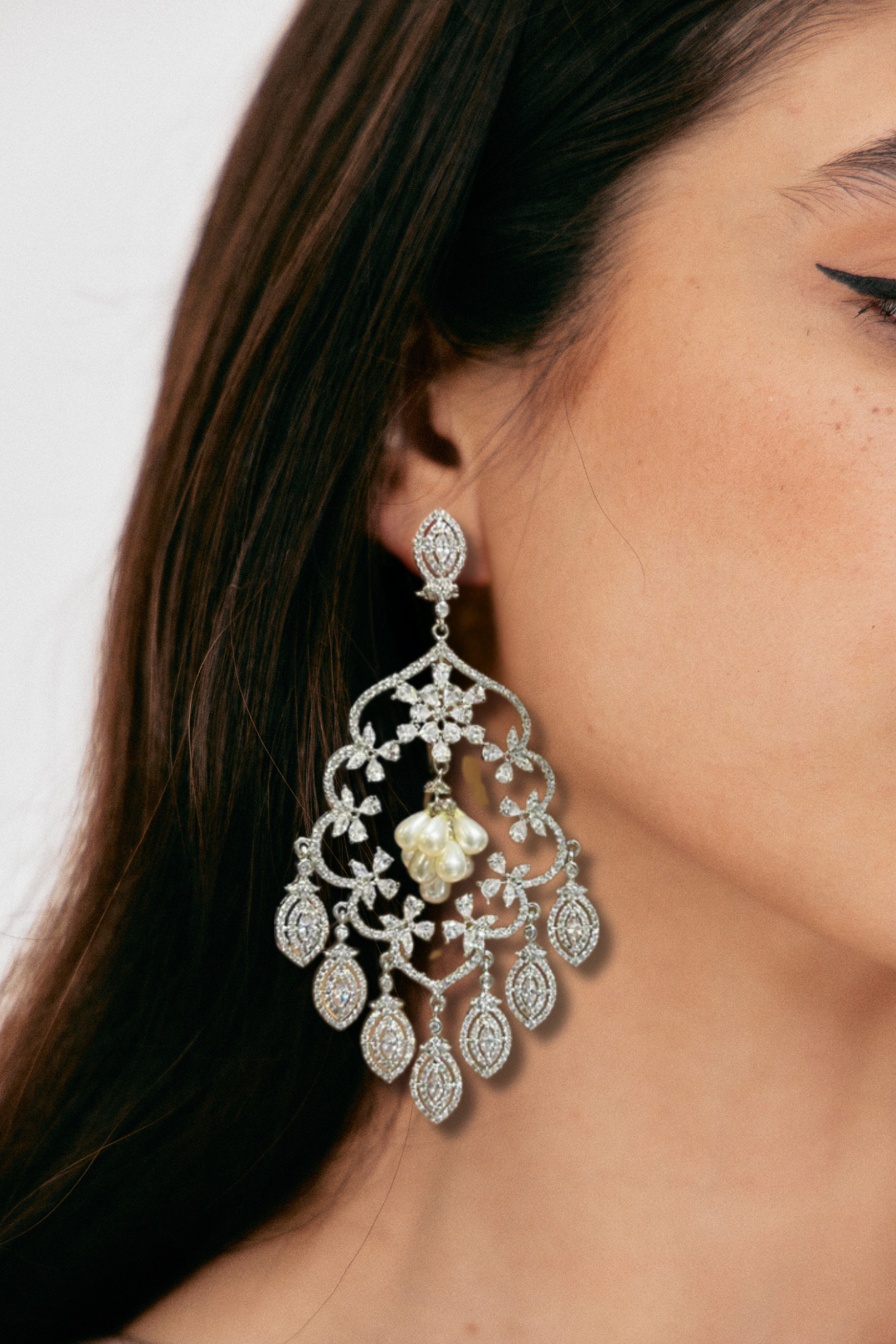 Julia Rhodium-Plated Statement Earrings with intricate detailing, 4.5-inch length, lightweight design, adorned with sparkling stones and pear-shaped dangles.