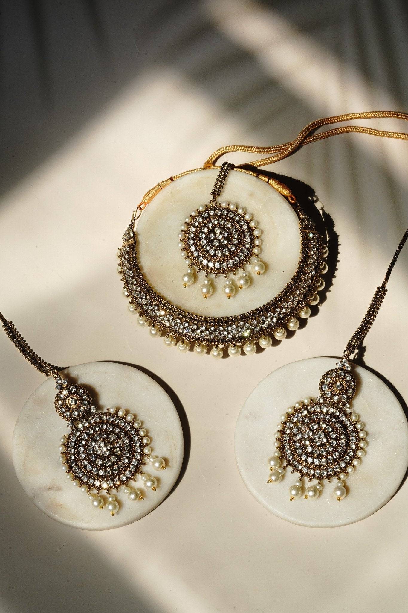 Arooj Handcrafted Pakistani Necklace Set - Antique gold-plated necklace, chandbali earrings, and maang tikka with pearl trim and sparkling white stones.