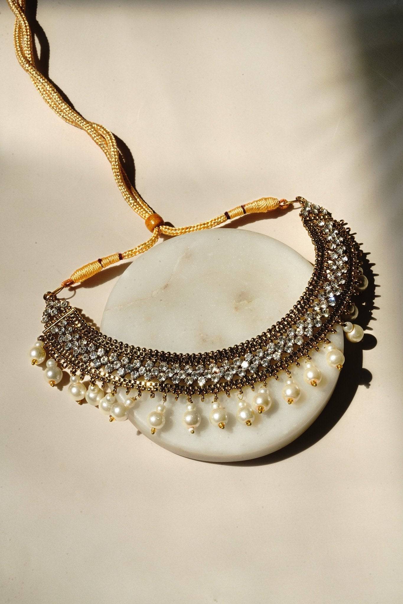 Arooj Handcrafted Pakistani Necklace Set - Antique gold-plated necklace, chandbali earrings, and maang tikka with pearl trim and sparkling white stones.