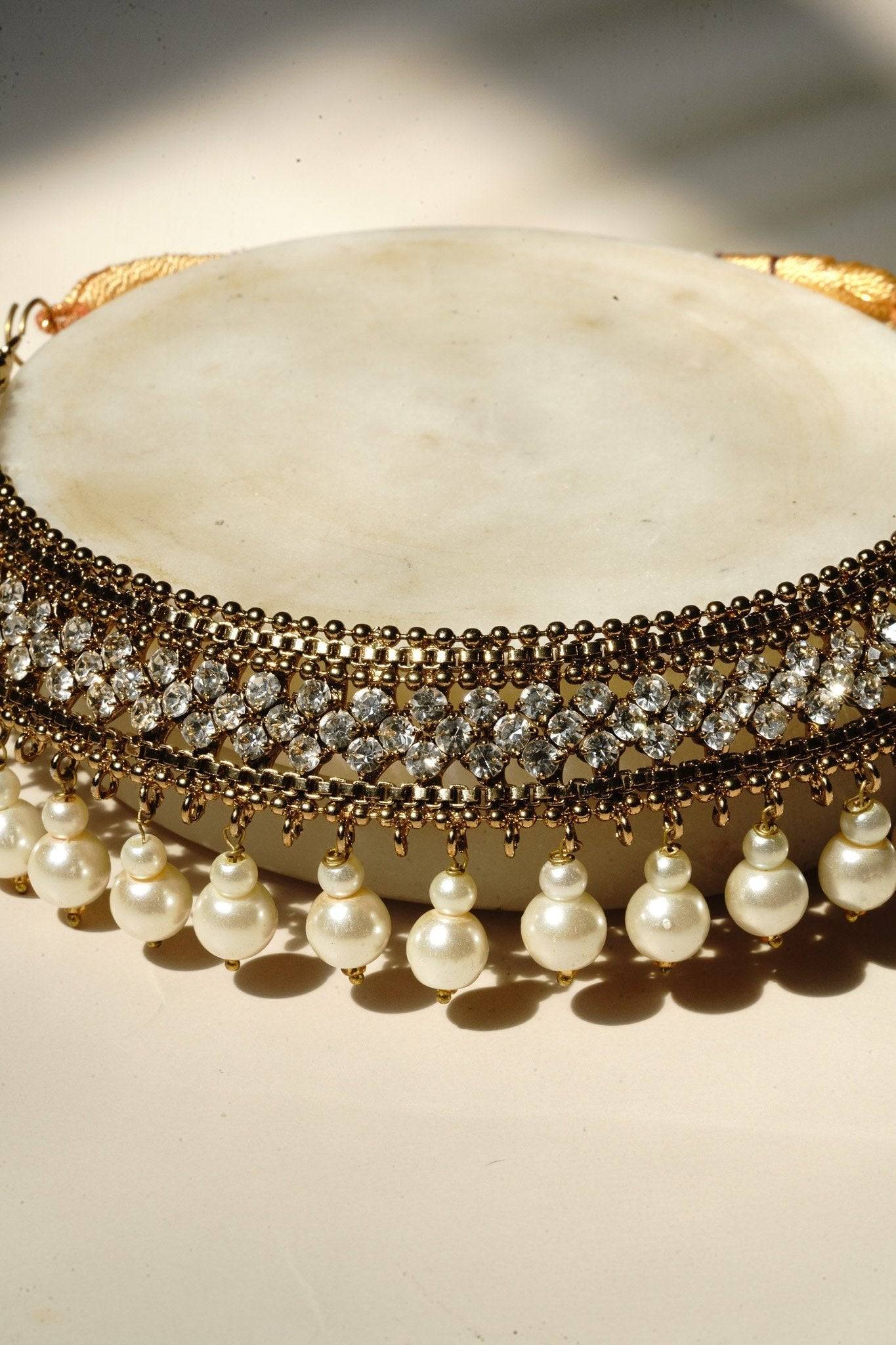 Arooj Handcrafted Pakistani Necklace Set - Antique gold-plated necklace, chandbali earrings, and maang tikka with pearl trim and sparkling white stones.