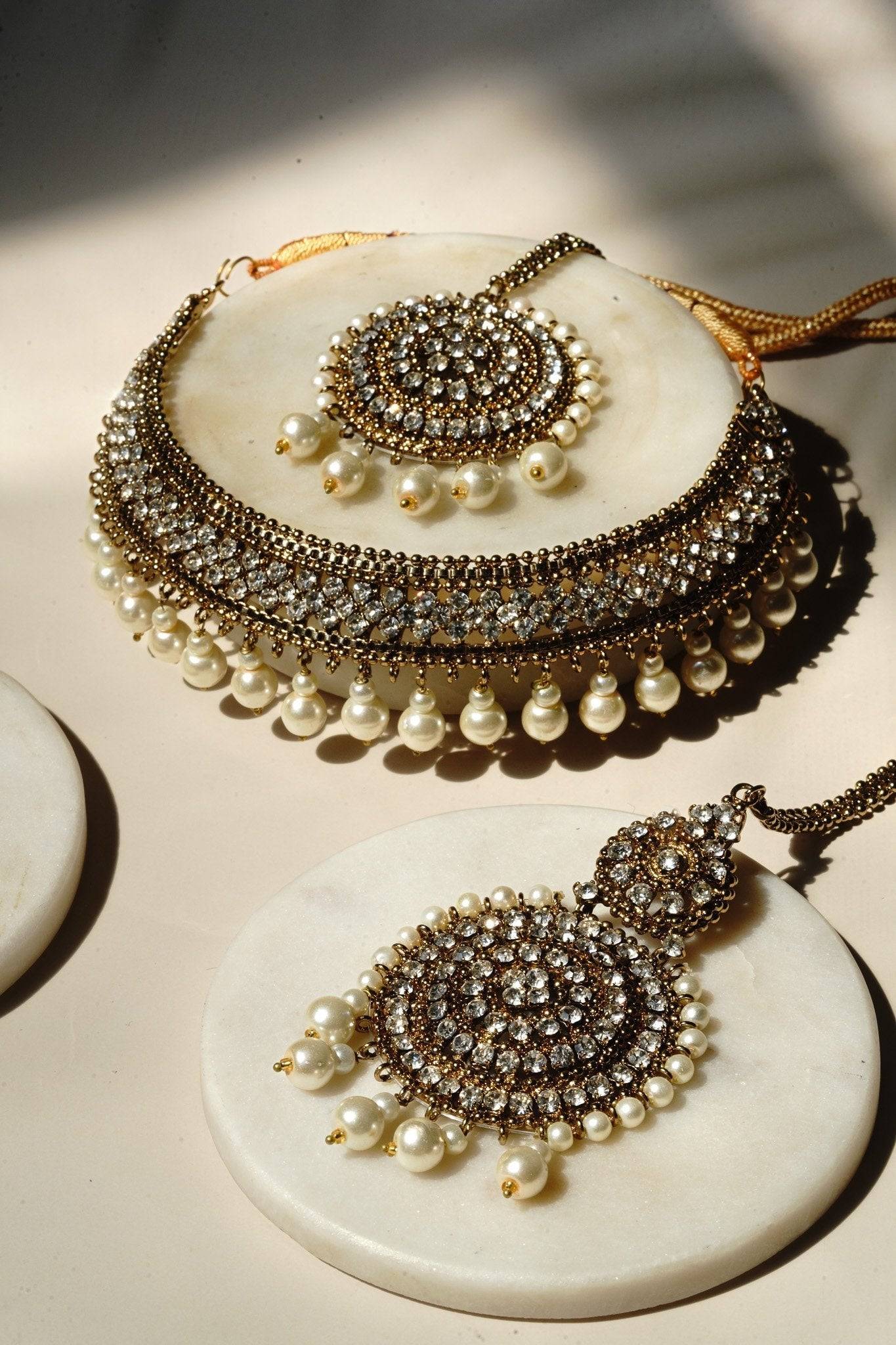 Arooj Handcrafted Pakistani Necklace Set - Antique gold-plated necklace, chandbali earrings, and maang tikka with pearl trim and sparkling white stones.