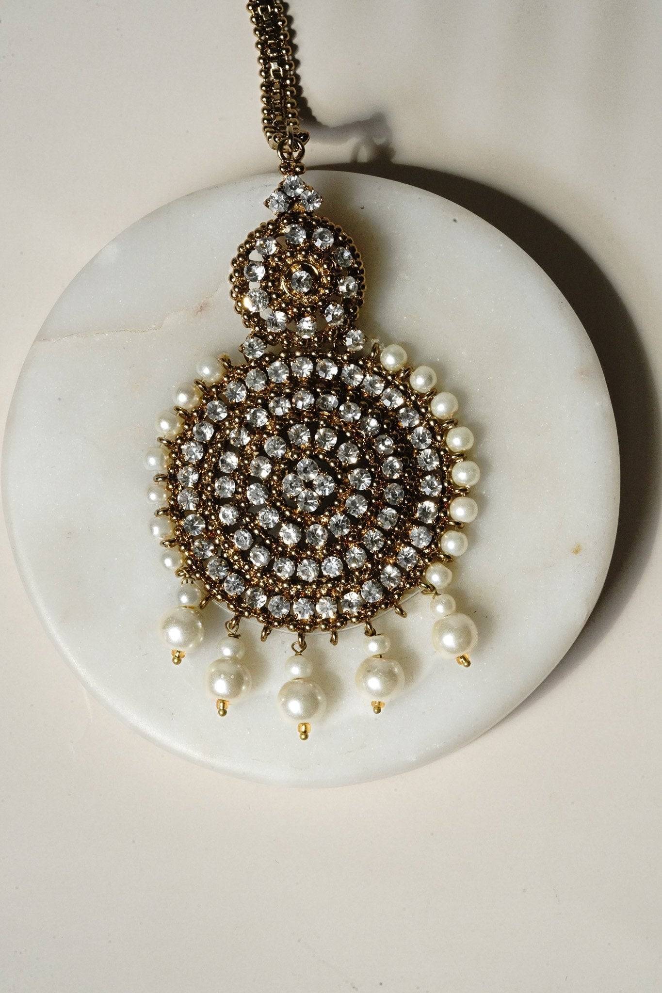 Arooj Handcrafted Pakistani Necklace Set - Antique gold-plated necklace, chandbali earrings, and maang tikka with pearl trim and sparkling white stones.