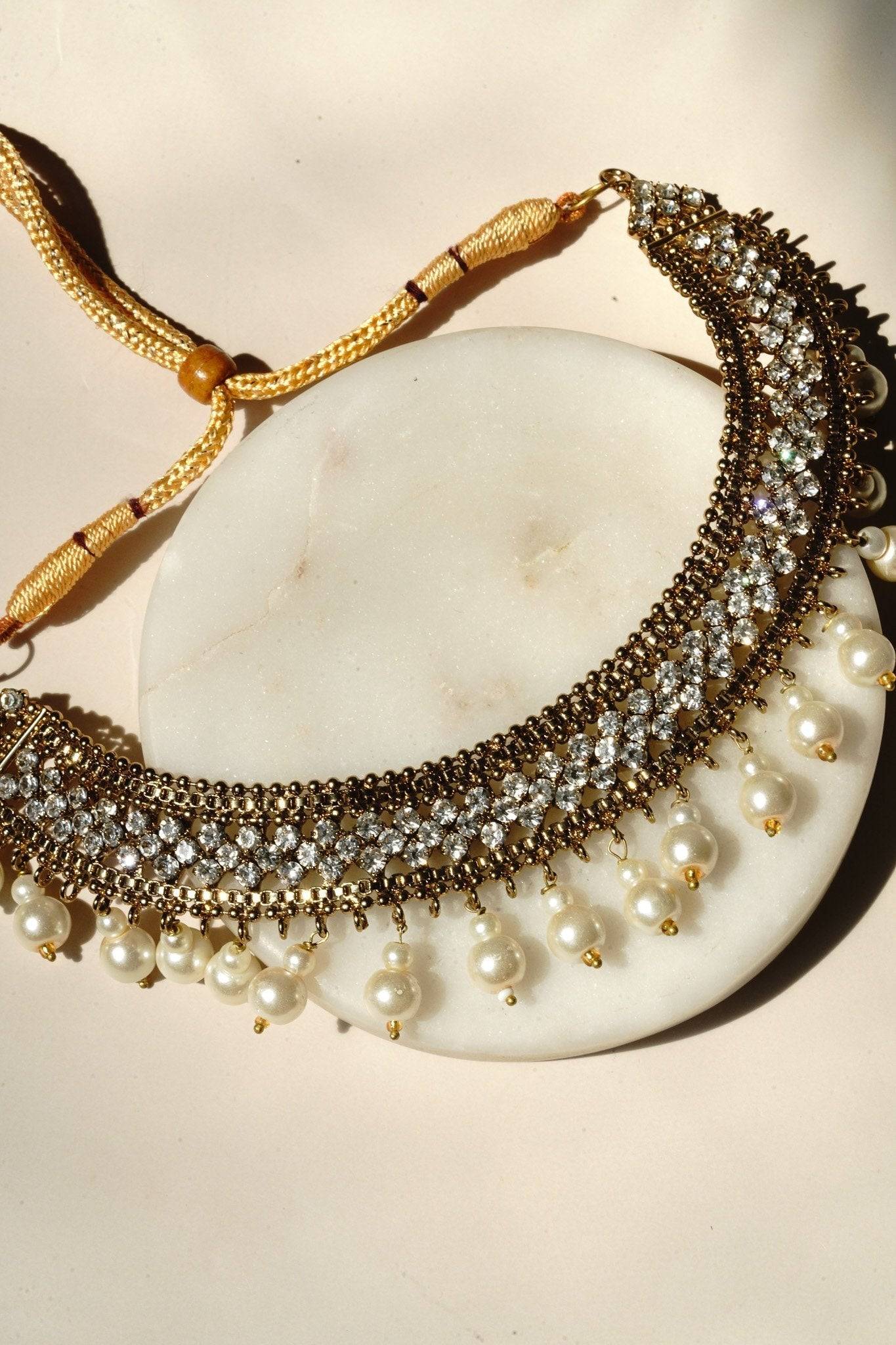 Arooj Handcrafted Pakistani Necklace Set - Antique gold-plated necklace, chandbali earrings, and maang tikka with pearl trim and sparkling white stones.