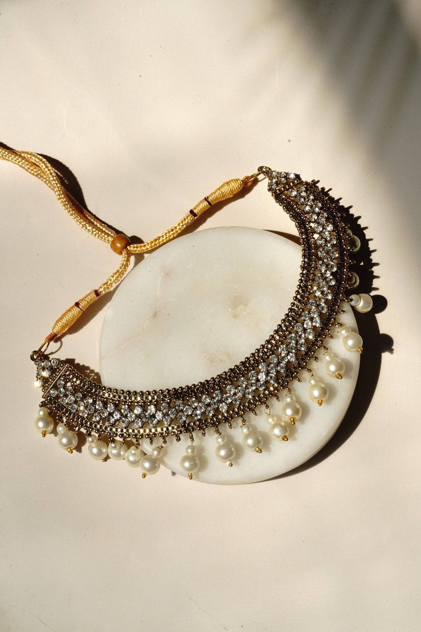 Arooj Handcrafted Pakistani Necklace Set - Antique gold-plated necklace, chandbali earrings, and maang tikka with pearl trim and sparkling white stones.