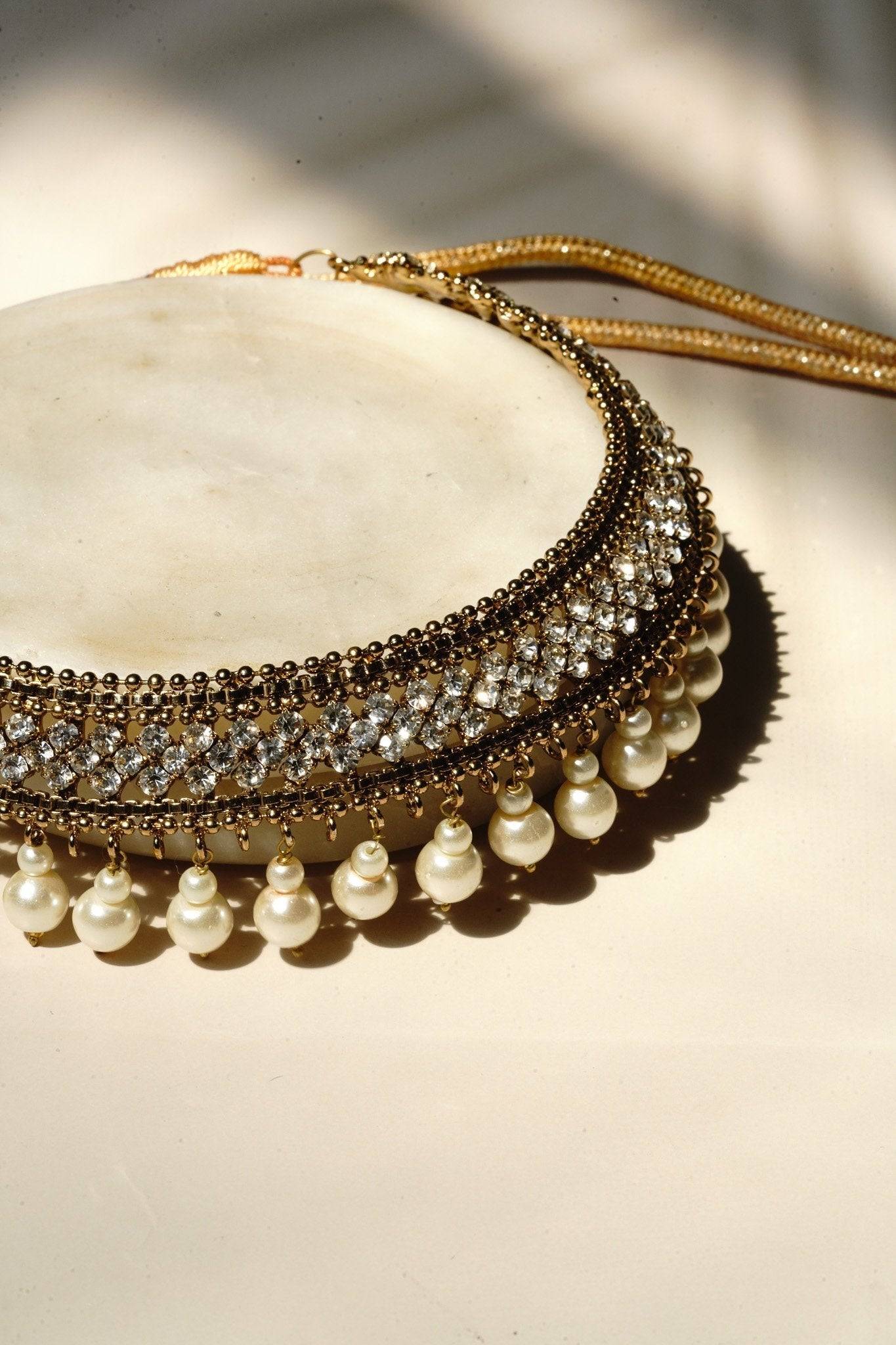 Arooj Handcrafted Pakistani Necklace Set - Antique gold-plated necklace, chandbali earrings, and maang tikka with pearl trim and sparkling white stones.