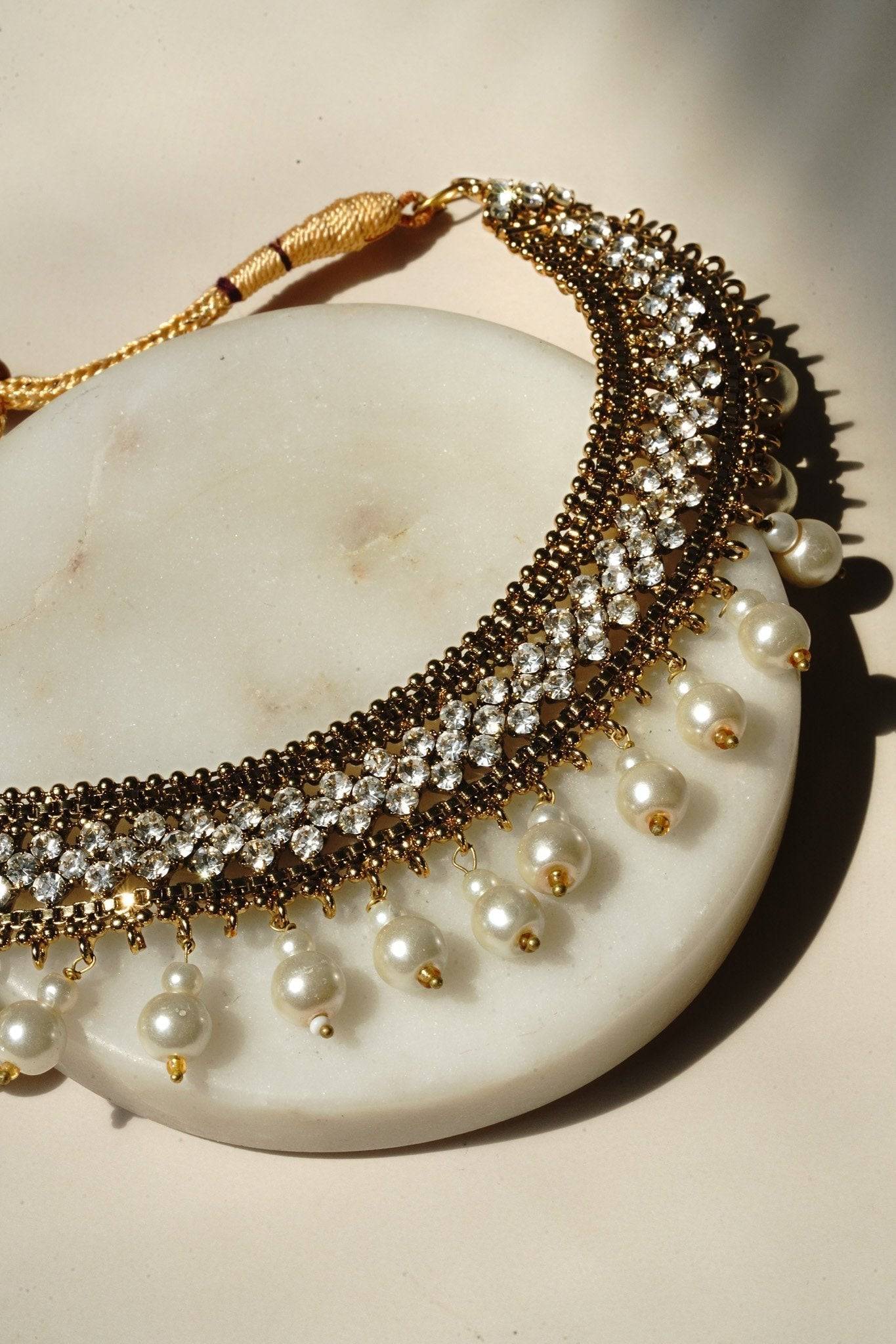 Arooj Handcrafted Pakistani Necklace Set - Antique gold-plated necklace, chandbali earrings, and maang tikka with pearl trim and sparkling white stones.