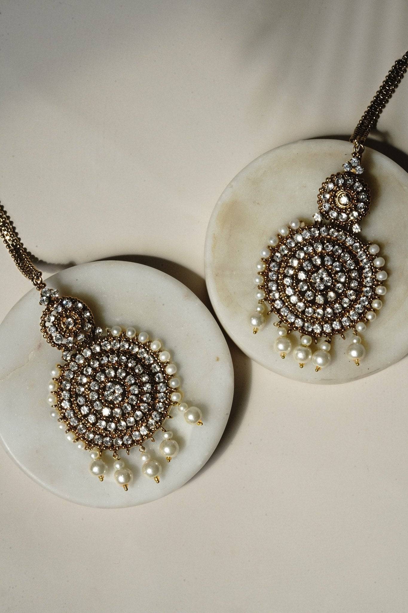 Arooj Handcrafted Pakistani Necklace Set - Antique gold-plated necklace, chandbali earrings, and maang tikka with pearl trim and sparkling white stones.