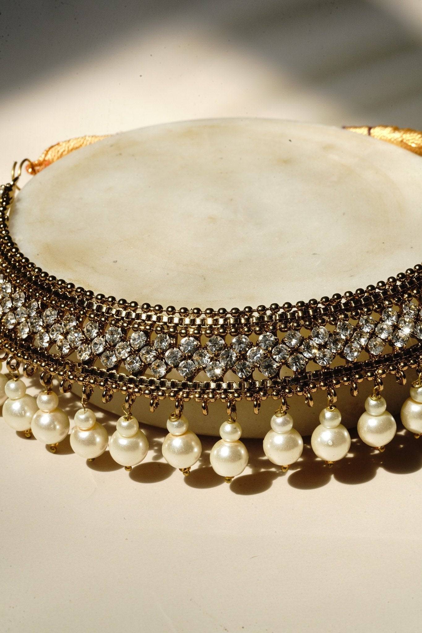 Arooj Handcrafted Pakistani Necklace Set - Antique gold-plated necklace, chandbali earrings, and maang tikka with pearl trim and sparkling white stones.