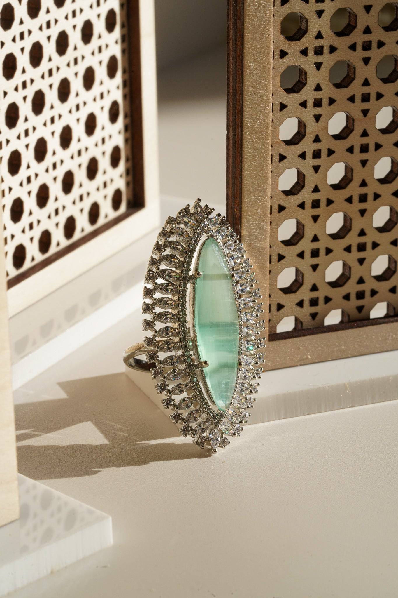 Januvia Marquise Cut Adjustable AD Statement Ring - Rhodium-plated with white and light mint green AD stones, featuring a large marquise-cut stone.