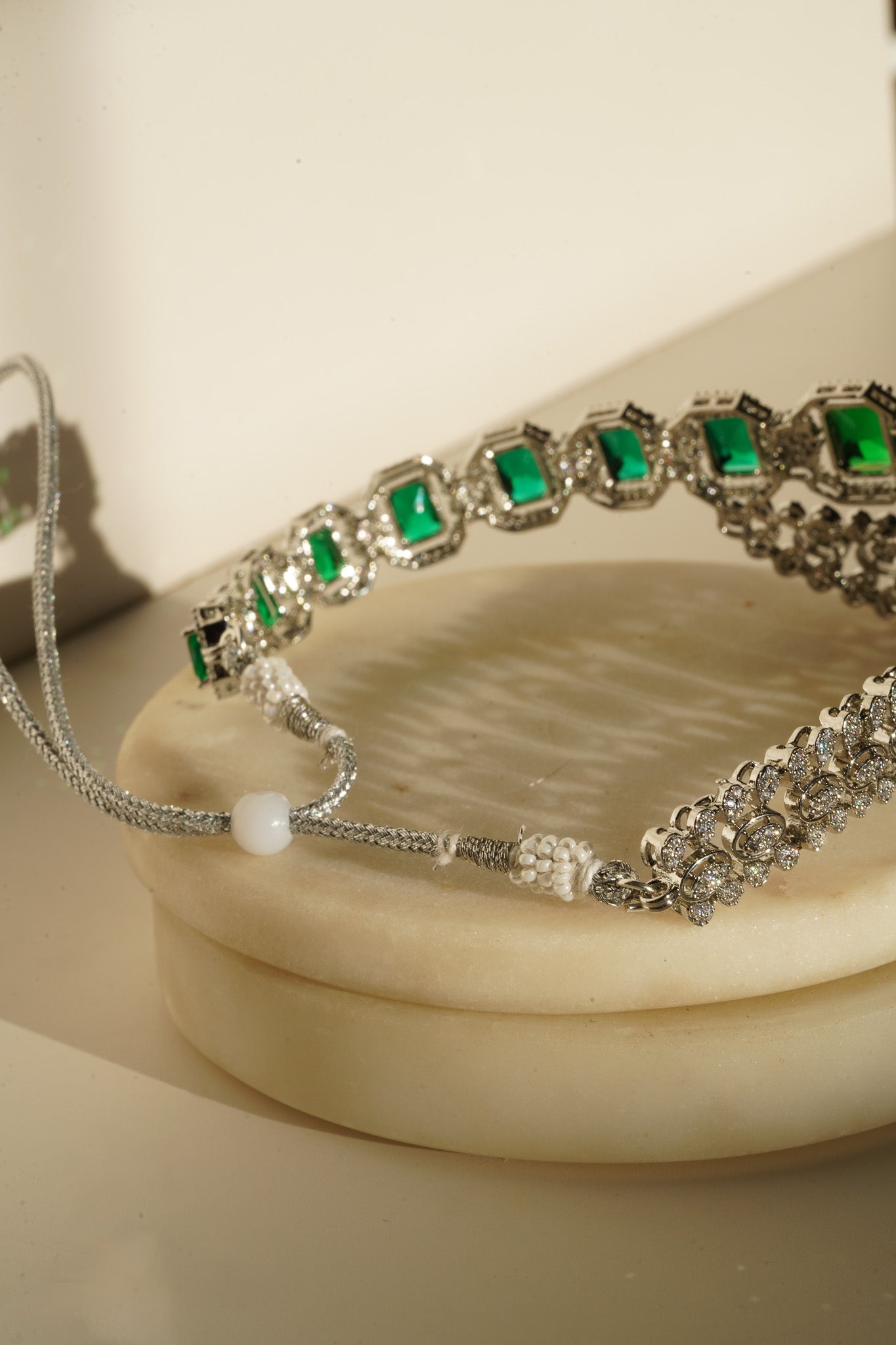 Mahi Asymmetrical Choker Necklace Set - Rhodium-plated with AD stones, available in silver & green, silver & ruby, and silver & sapphire blue, perfect for contemporary elegance.